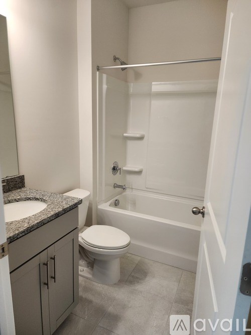 A bathroom with a toilet, sink, and bathtub.