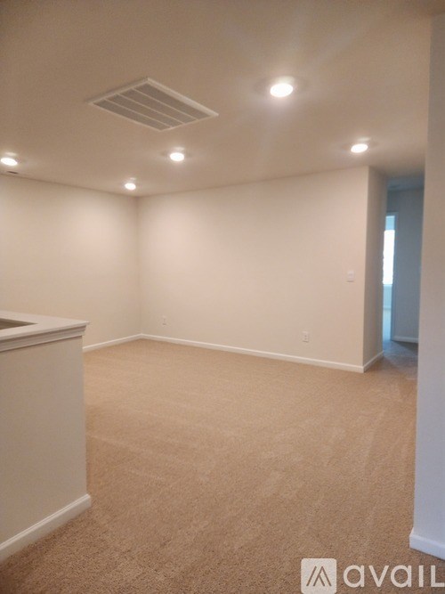 A room with beige carpet and white walls.