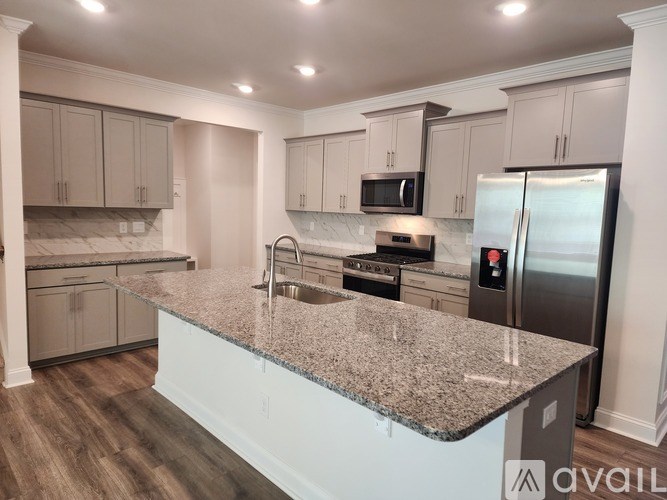 A kitchen with granite countertops and stainless steel appliances.
