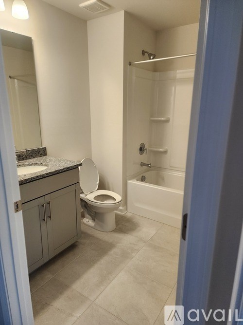 A bathroom with a toilet, sink, and bathtub.