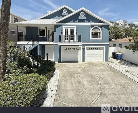 A two-story house with a blue exterior and white trim.