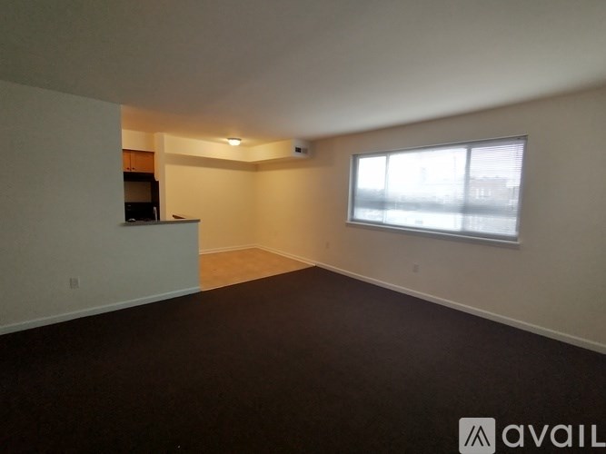 A room with a window and a television set.