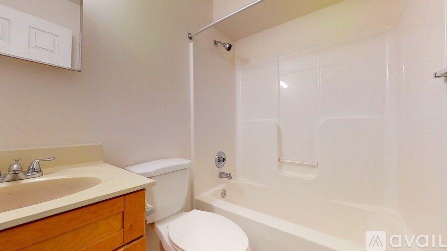 A bathroom with a toilet, sink, and bathtub.