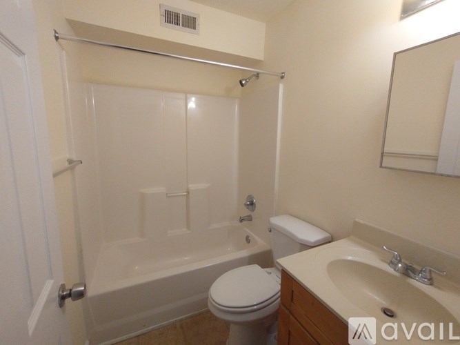 A bathroom with a toilet, sink, and bathtub.