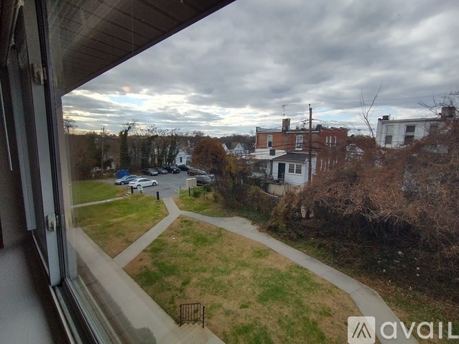 A view from a window looking out at a residential street.