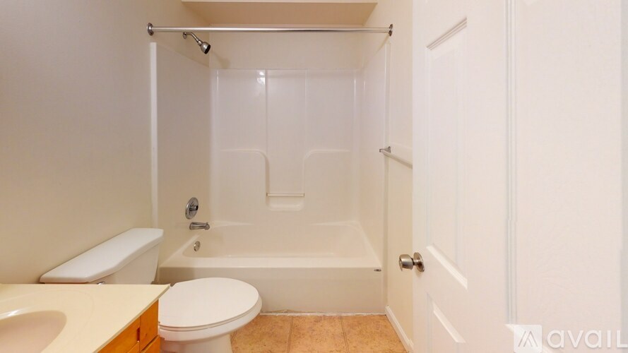 A bathroom with a toilet, sink, and bathtub.