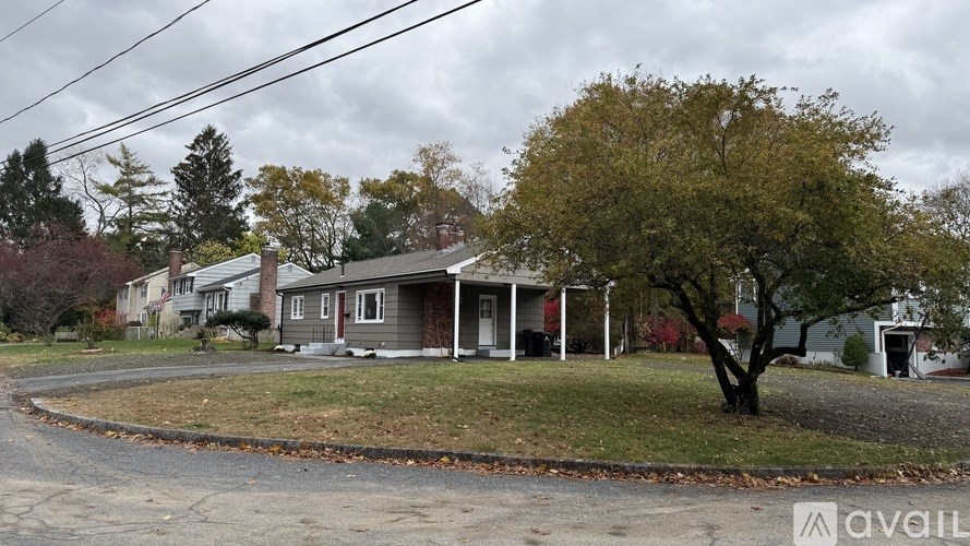 A house with a tree in front of it.