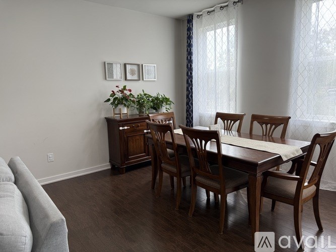 A dining room with a table set for four.
