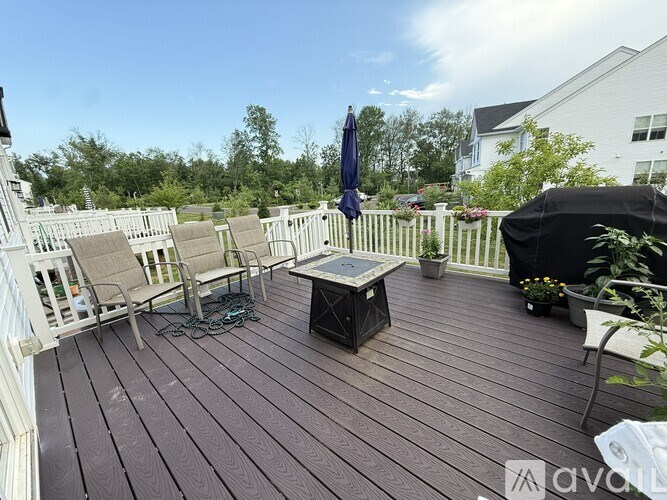 A wooden deck with a table and chairs.