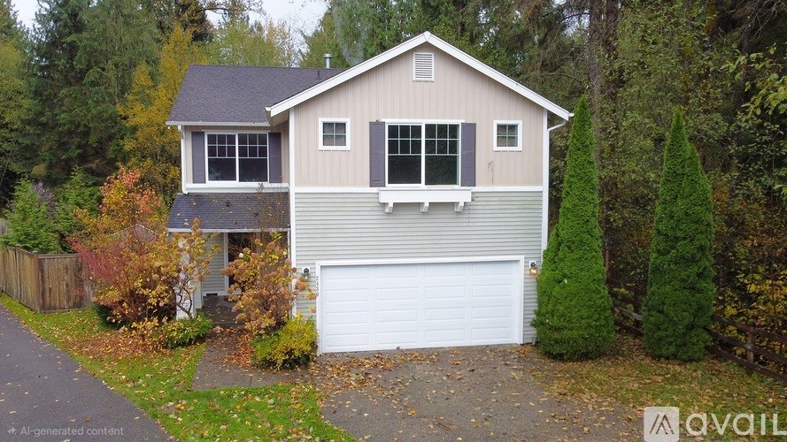A house with a garage and a driveway in front of it.
