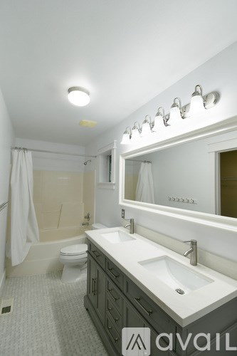 A bathroom with a white sink and a white toilet.