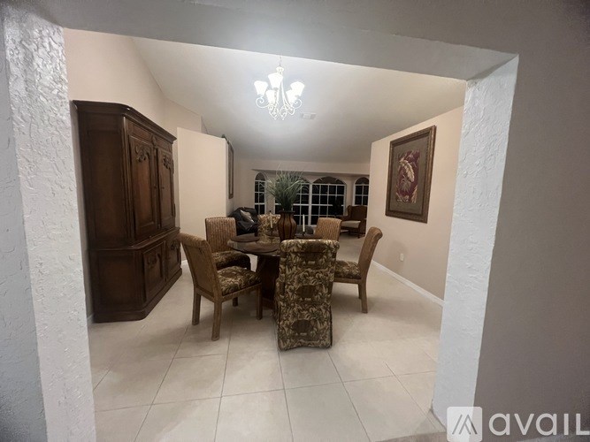 A dining room with a table set for six.