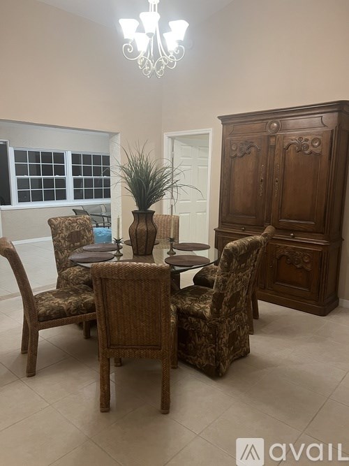 A dining room with a wooden table and chairs.