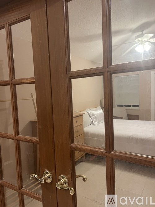 A wooden door with glass panels and a brass handle.