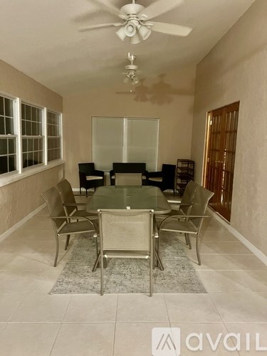 A dining room with a glass table and chairs.