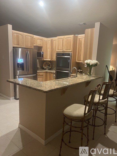 A kitchen with wooden cabinets and granite countertops.