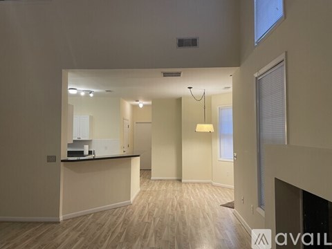 A spacious living area with a kitchenette and a dining area.