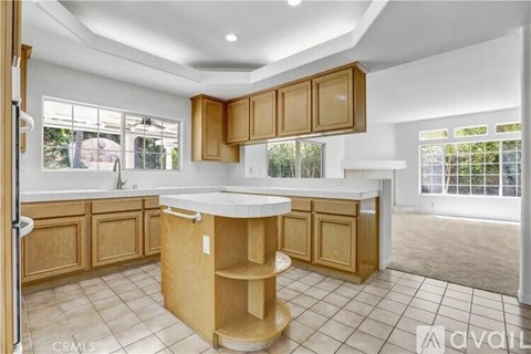 A kitchen with wooden cabinets and a white countertop.