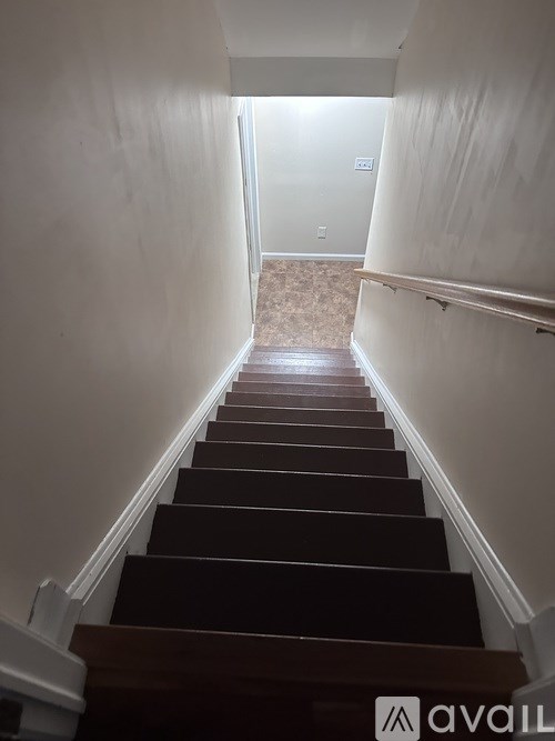 A long flight of stairs leading to a door.