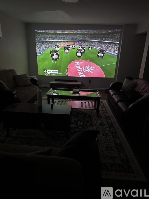 A living room with a television displaying a soccer game.