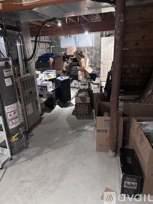 A room with a lot of boxes and a machine on the left.