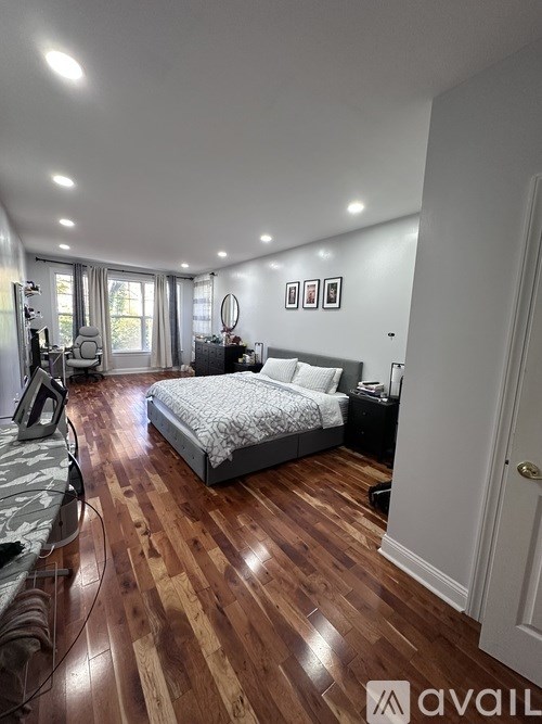 A bedroom with a bed, dresser, and mirror.