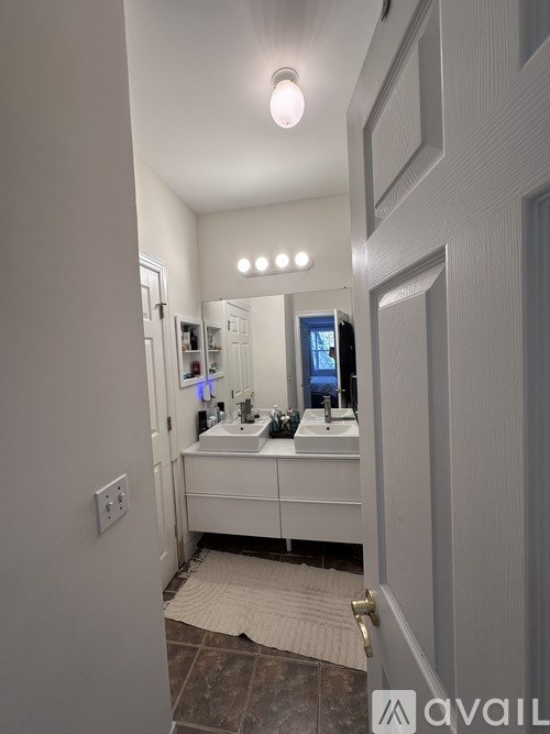 A bathroom with a sink and mirror.