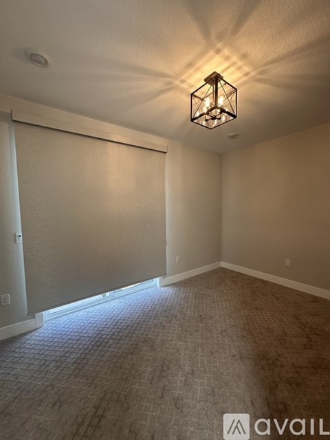 A room with a carpeted floor and a ceiling light.