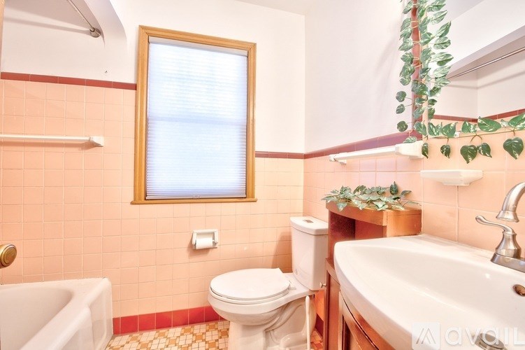 A bathroom with a toilet, sink, and bathtub.