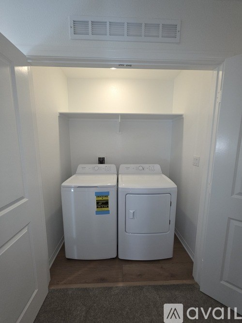 A small laundry room with a washer and dryer.