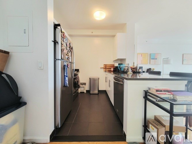 A kitchen with a refrigerator, sink, and oven.