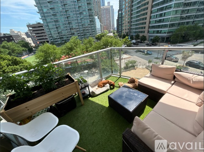 A balcony with a table, chairs, and a planter.
