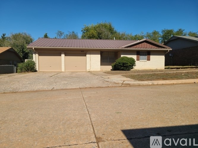 A house with a brown roof and a garage door is for sale.