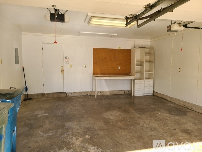 A room with a white wall and a brown board on the wall.