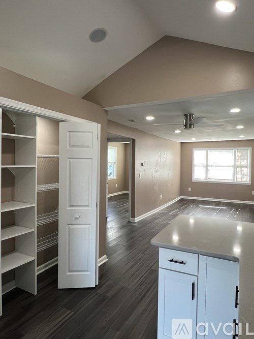 A room with a white cabinet and a white door.
