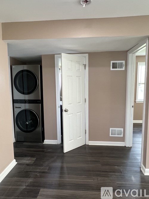 A black washer and dryer in a laundry room.