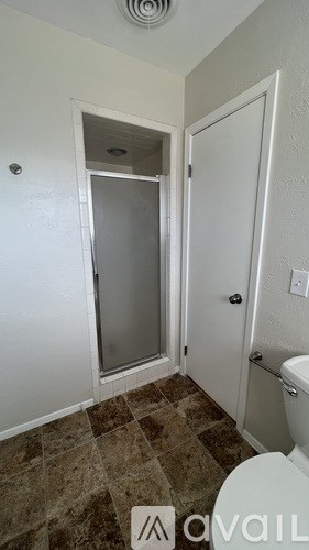 A bathroom with a toilet, sink, and shower.