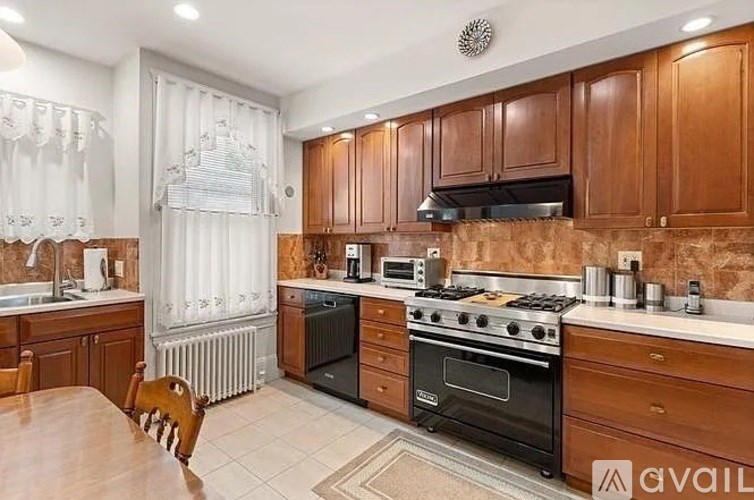 A kitchen with wooden cabinets and a black oven.
