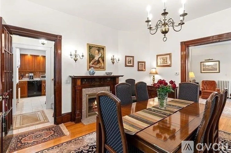 A dining room with a wooden table and chairs.