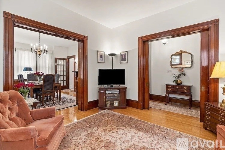 A living room with a brown sofa and a fireplace.