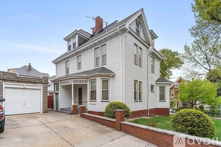 A two-story house with a garage on the left.