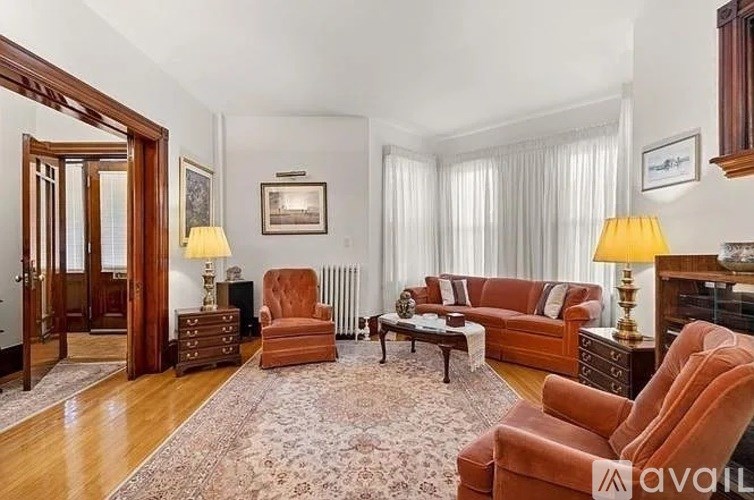 A living room with a rug and a couch.