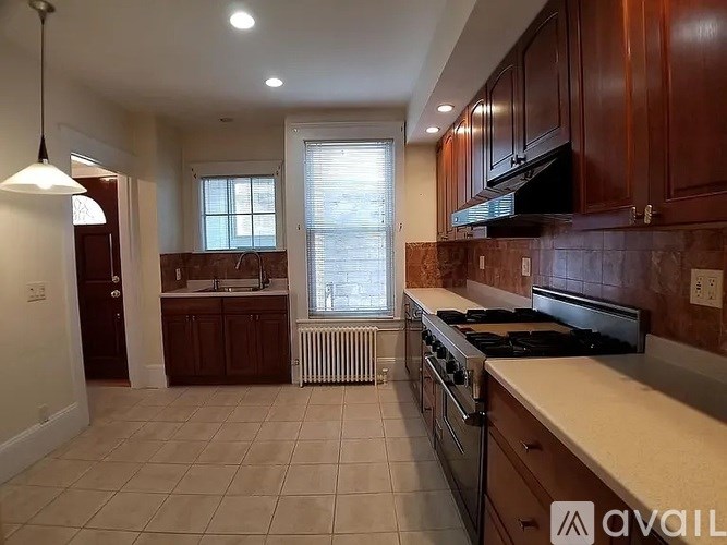 A kitchen with brown cabinets and a white countertop.