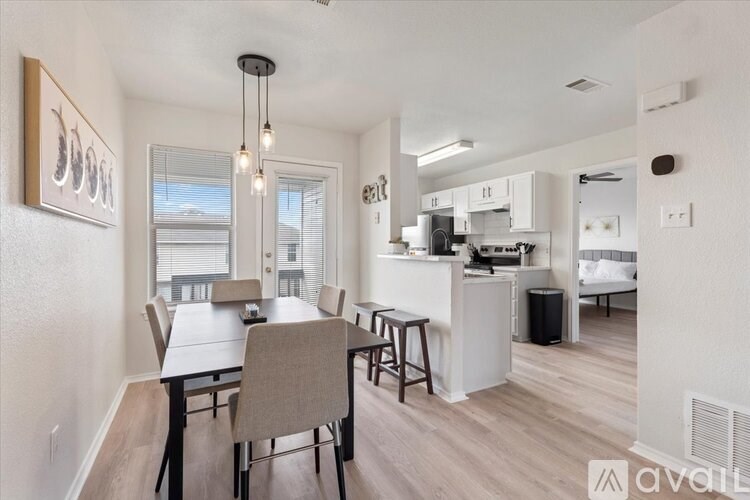 A dining area with a table and chairs is shown in the image.