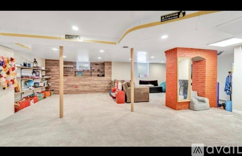 A room with a brick pillar and a sign that says "caution".