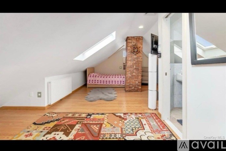 A room with a brick chimney and a patterned rug on the floor.