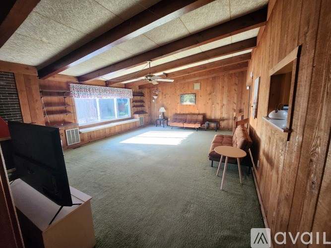 A living room with a flat screen TV and a couch.