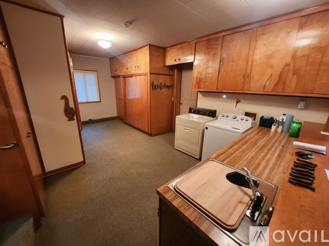 A kitchen with wooden cabinets and a wooden counter top.