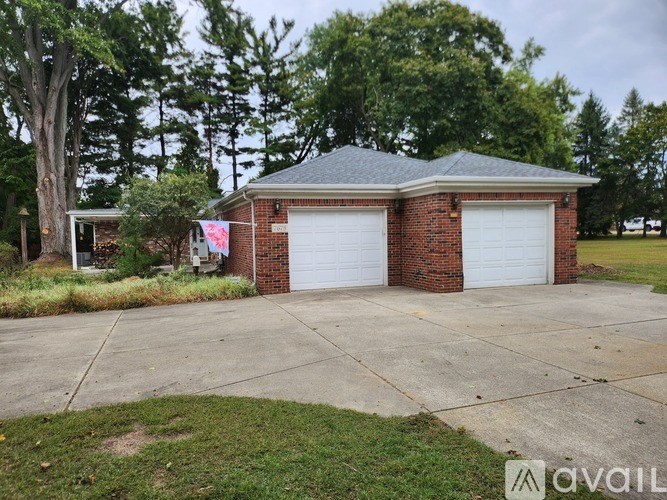 A two-car garage with a brick facade and a flag hanging on the left side.
