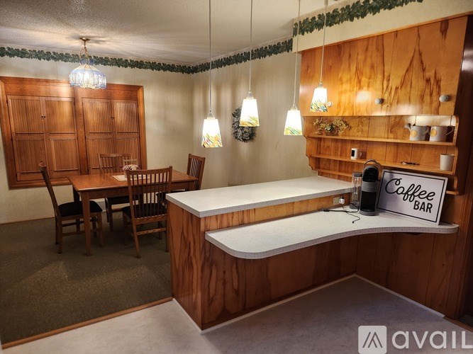 A coffee bar area with a wooden table and chairs.